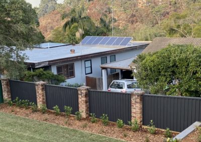 Colorbond Fence panels between brick pillars